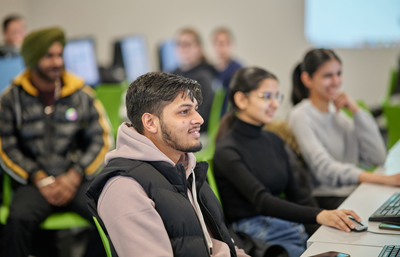 A group of students listening to library instruction session in the classroom.