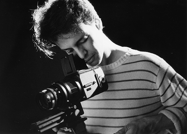 Black and white picture of a student with a camera