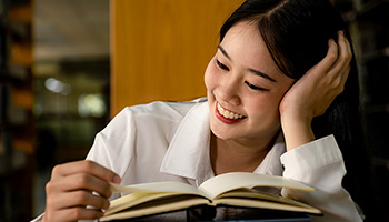 Young woman reading a textbook