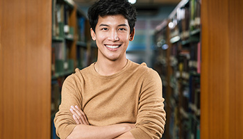 Young man smiling in the library