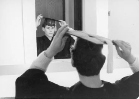 Graduating student with cap in mirror