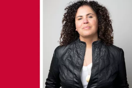 Safiya Noble stands smiling at the camera. Against a red background is a white banner with text reading “Dean’s Lecture on Information + Society.” Text underneath: “An evening with Safiya Noble. November 15, 6:30pm PT. Room 1200-1500, Segal Building, SFU 